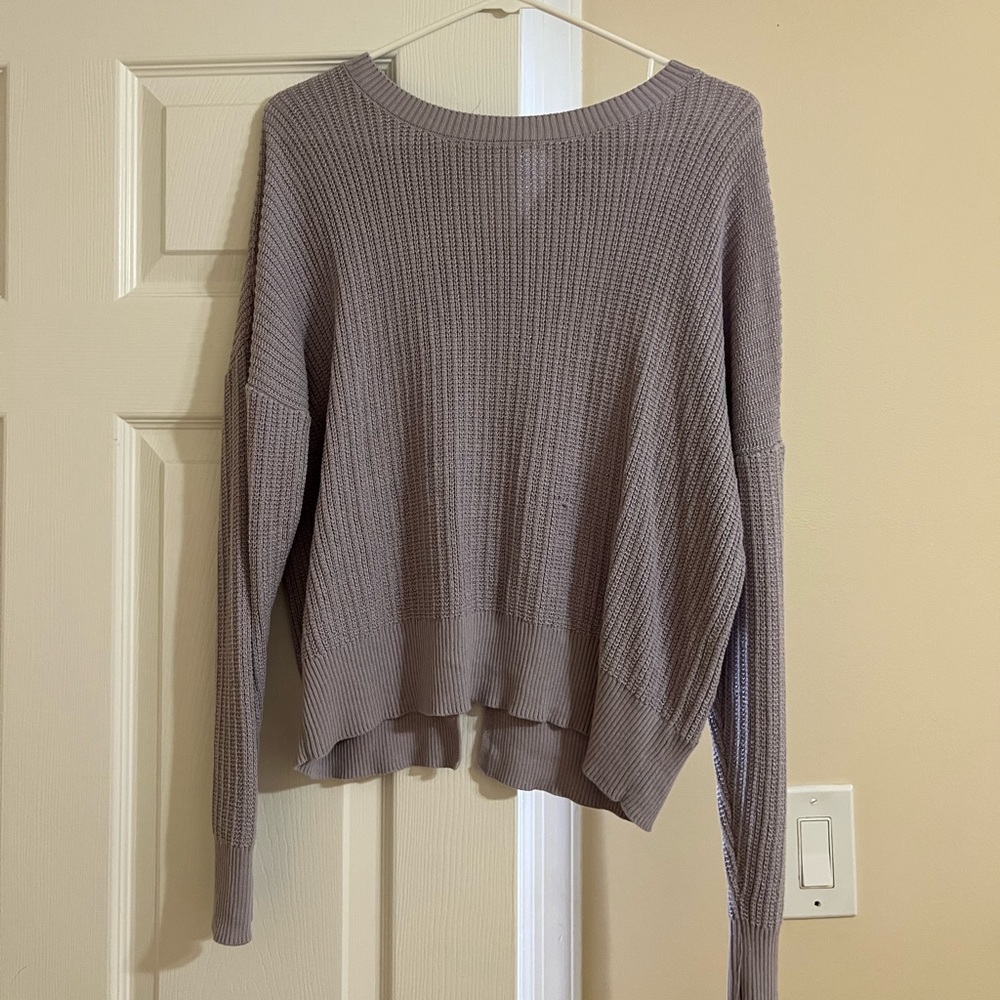 Purple sweater with open back design